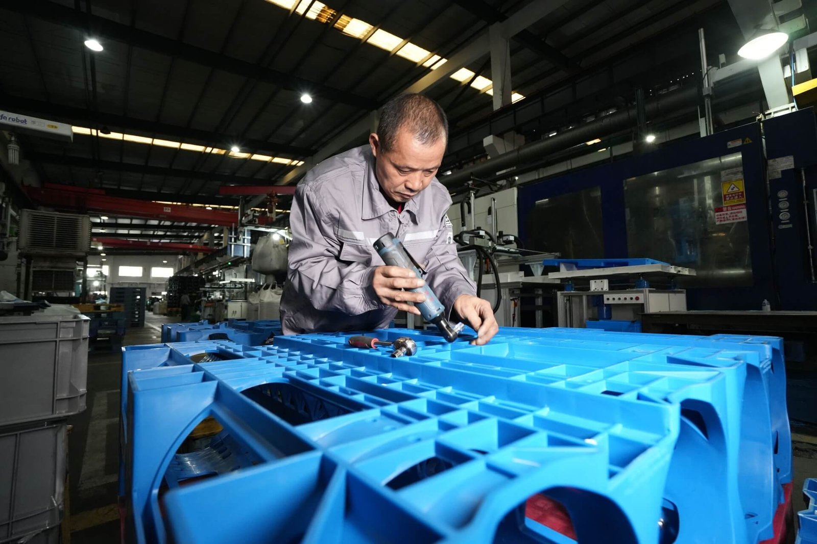 A Preface Plast Worker on a Plastic Pallet in workshop